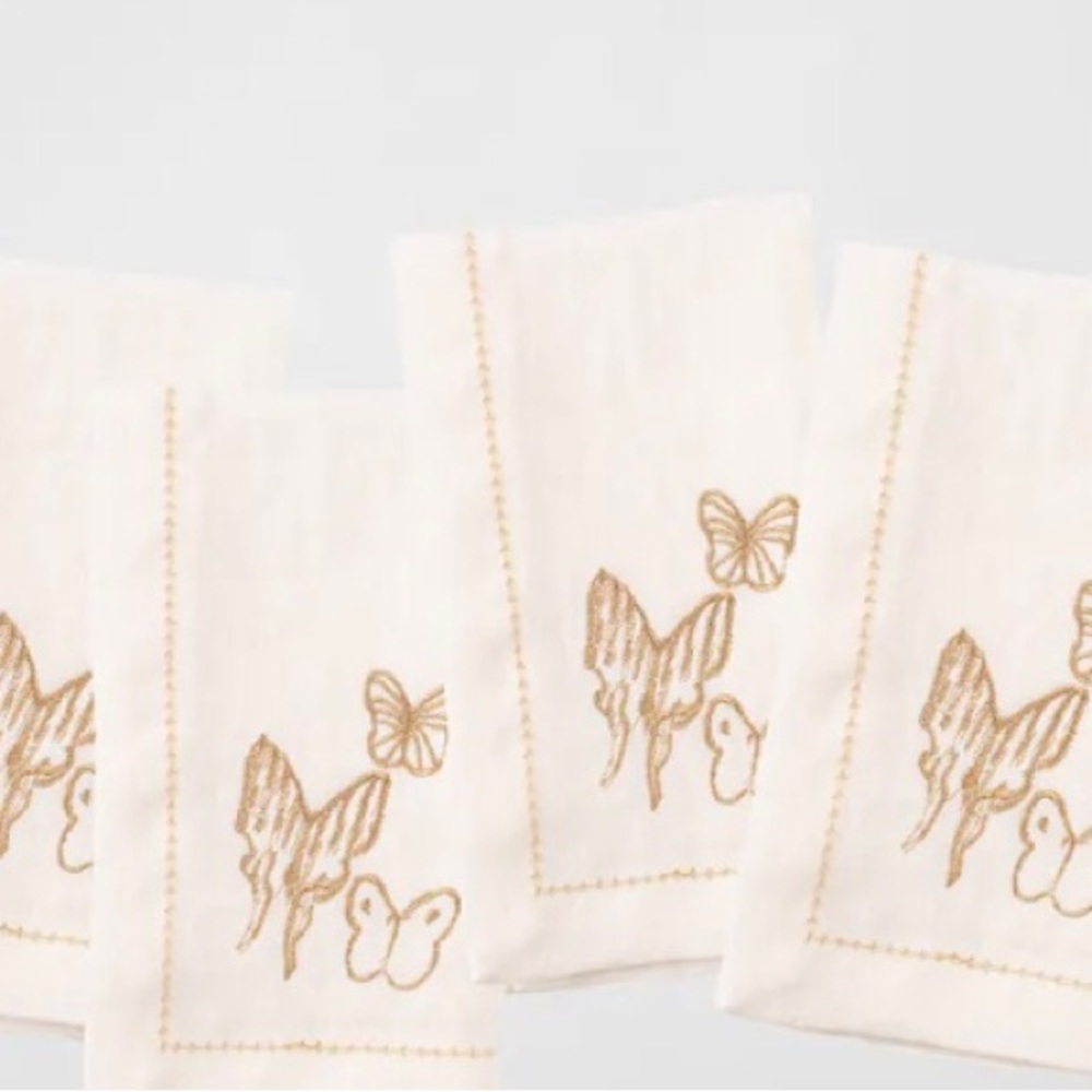 Hunt Slonem linen napkins.  Ecru with gold, embroidered butterflies.  Brand new.
